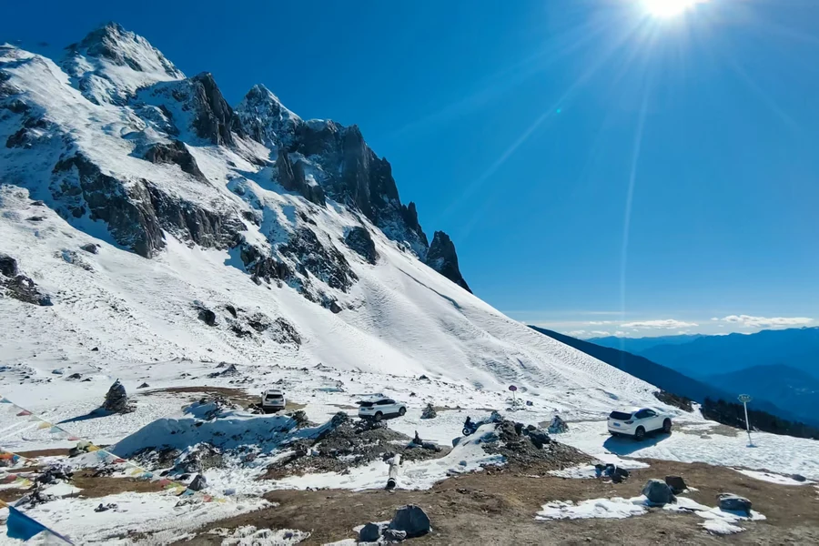 Snow-covered mountain peaks beneath a bright blue sky